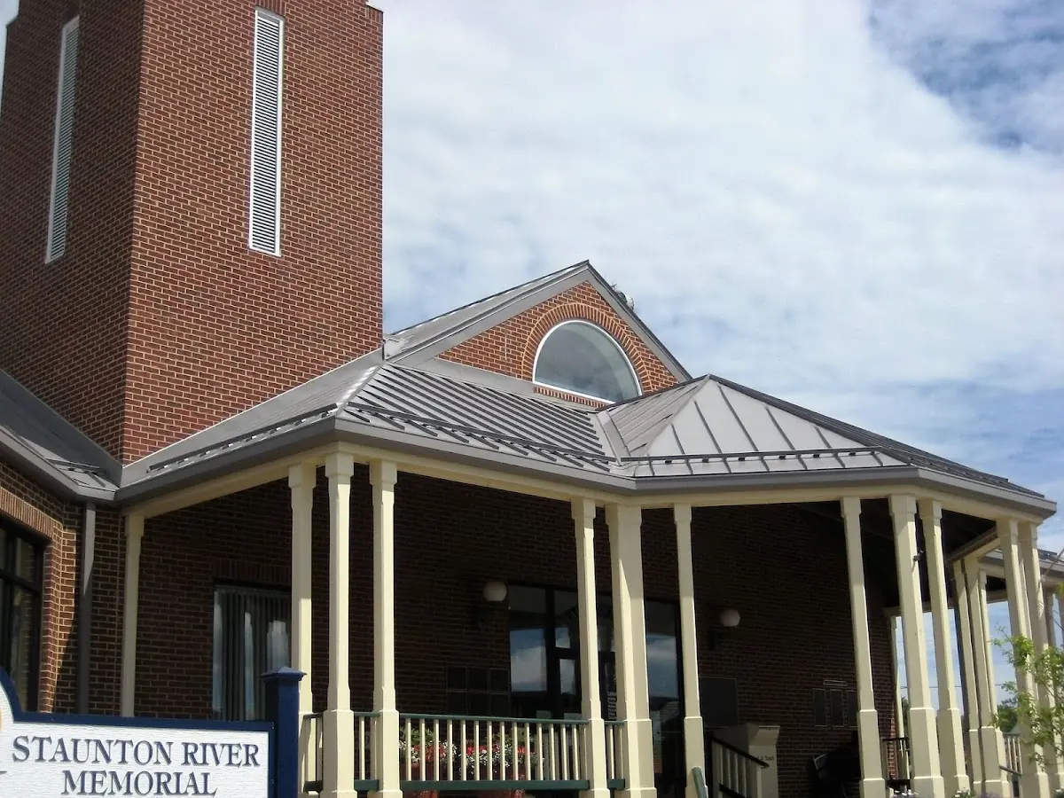 Skilled roofing craftsmen working on a residential roof in West Liberty